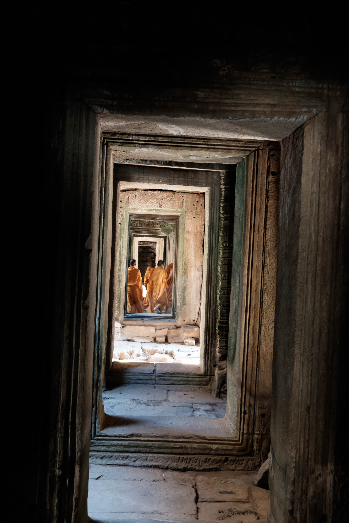 Monks walking a hallway - Cambodia